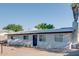 Low angle view of the front of the house with xeriscaped yard and blue door at 217 E Bruce Ave, Gilbert, AZ 85234