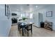 Open kitchen with stainless steel appliances, white cabinets, and dining space at 217 E Bruce Ave, Gilbert, AZ 85234