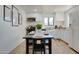 Bright eat-in kitchen featuring stainless steel appliances, white cabinets, and updated countertops at 217 E Bruce Ave, Gilbert, AZ 85234