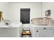 Functional laundry room with a washer, a dryer, and shelving, providing convenient space for laundry tasks at 217 E Bruce Ave, Gilbert, AZ 85234
