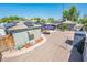 An aerial view of the backyard shows multiple buildings and solar panels on the roofs at 2221 W Mitchell Dr, Phoenix, AZ 85015