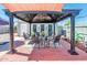 Relaxing backyard with covered pergola, patio furniture, and decorative details at 2221 W Mitchell Dr, Phoenix, AZ 85015