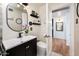 Well-appointed bathroom features a modern vanity, decorative mirror, and stylish decor, creating a tranquil retreat at 2221 W Mitchell Dr, Phoenix, AZ 85015