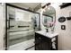 Modern bathroom showcases a sleek vanity, glass-enclosed shower, and contemporary fixtures, creating a spa-like experience at 2221 W Mitchell Dr, Phoenix, AZ 85015