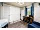 Functional and compact bedroom featuring a murphy bed, storage cabinets, and a window with natural light at 2221 W Mitchell Dr, Phoenix, AZ 85015