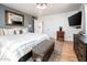 Spacious bedroom boasts chic design with a large bed, accent wall, mounted TV, and decorative furnishings at 2221 W Mitchell Dr, Phoenix, AZ 85015