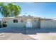 Quaint one-story home featuring solar panels and a welcoming entrance at 2221 W Mitchell Dr, Phoenix, AZ 85015