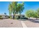 Charming single-story home with mature shade tree and a well-maintained front yard at 2221 W Mitchell Dr, Phoenix, AZ 85015