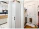Hallway featuring storage cabinet, water heater, and convenient access to the exterior, combining utility and convenience at 2221 W Mitchell Dr, Phoenix, AZ 85015