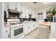 Efficient kitchen features white cabinets, updated fixtures, and a center island at 2221 W Mitchell Dr, Phoenix, AZ 85015