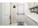 Bright laundry area features a door to the exterior, laundry machines and a storage cabinet for household needs at 2221 W Mitchell Dr, Phoenix, AZ 85015
