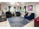Cozy living room featuring a beautiful area rug, tile floors, and well-lit windows at 2221 W Mitchell Dr, Phoenix, AZ 85015