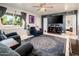 Inviting living room with updated flooring, a ceiling fan, and abundant natural light at 2221 W Mitchell Dr, Phoenix, AZ 85015