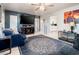 Cozy living room features an entertainment center and an opening into kitchen at 2221 W Mitchell Dr, Phoenix, AZ 85015