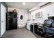 Multi-purpose room featuring appliances, storage, and work area at 2221 W Mitchell Dr, Phoenix, AZ 85015