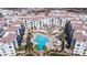 An aerial view of a luxurious residential complex with a large pool, sun loungers, and well-maintained landscaping at 2511 W Queen Creek Rd # 166, Chandler, AZ 85248