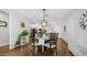 Dining area featuring hardwood floors, modern lighting, and open access to the kitchen at 2511 W Queen Creek Rd # 166, Chandler, AZ 85248