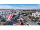 View of a residential complex featuring an American flag, ample parking, and well-maintained landscaping at 2511 W Queen Creek Rd # 166, Chandler, AZ 85248