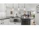 Modern kitchen with stainless steel sink, black countertops, and contemporary pendant lighting at 2511 W Queen Creek Rd # 166, Chandler, AZ 85248