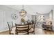 Open concept living room with dining area, hardwood floors and balcony access at 2511 W Queen Creek Rd # 166, Chandler, AZ 85248