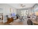 Cozy living room with comfortable seating, ceiling fan, and sliding glass doors to balcony at 2511 W Queen Creek Rd # 166, Chandler, AZ 85248