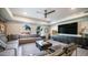 Cozy living room featuring modern furnishings, a ceiling fan, and large windows offering natural light and a comfortable ambiance at 2511 W Queen Creek Rd # 166, Chandler, AZ 85248