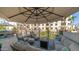 Spacious patio featuring an outdoor seating area, fire pit, and umbrella at 2511 W Queen Creek Rd # 166, Chandler, AZ 85248