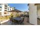 Outdoor dining set with umbrella offers comfortable seating and views of the community at 2511 W Queen Creek Rd # 166, Chandler, AZ 85248