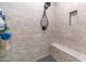 A tiled shower featuring a shower bench, a built-in shampoo shelf, and a modern shower head at 2511 W Queen Creek Rd # 166, Chandler, AZ 85248
