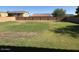 Large grassy backyard enclosed by a block fence, perfect for outdoor activities and relaxation at 259 E Montego Dr, Casa Grande, AZ 85122