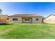 This backyard features lush green grass and a covered patio, perfect for outdoor activities at 259 E Montego Dr, Casa Grande, AZ 85122