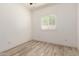 This bright bedroom features wood-look floors and a window that brings in natural light at 259 E Montego Dr, Casa Grande, AZ 85122