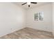 Bright bedroom features wood-look floors, a ceiling fan, and a window with backyard views at 259 E Montego Dr, Casa Grande, AZ 85122