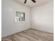 Bedroom featuring wood-look flooring and a bright window with shutters at 259 E Montego Dr, Casa Grande, AZ 85122