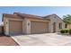 Exterior of home featuring a tile roof, a three-car garage, and desert landscaping at 259 E Montego Dr, Casa Grande, AZ 85122