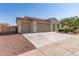 Charming single-story home with a three car garage, desert landscaping, and a tile roof at 259 E Montego Dr, Casa Grande, AZ 85122
