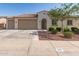 Charming single-story home with a three car garage, desert landscaping, and a tile roof at 259 E Montego Dr, Casa Grande, AZ 85122