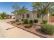 Single-story home featuring well maintained desert landscaping with mature shade trees and colorful flowering plants at 259 E Montego Dr, Casa Grande, AZ 85122