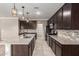 Open kitchen featuring granite countertops, stainless steel appliances, a central island, and dark cabinetry at 259 E Montego Dr, Casa Grande, AZ 85122