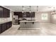Open kitchen featuring granite countertops, stainless steel appliances, dark cabinets, and a central island at 259 E Montego Dr, Casa Grande, AZ 85122