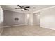 Spacious living room featuring neutral paint, large windows, ceiling fan, and tile flooring at 259 E Montego Dr, Casa Grande, AZ 85122