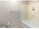 Clean bathroom featuring a bathtub, tiled walls, and neutral tones, creating a relaxing space at 295 N Rural Rd # 160, Chandler, AZ 85226