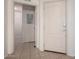 Bright entryway with tiled floors and a white front door, creating a welcoming entrance to the home at 295 N Rural Rd # 160, Chandler, AZ 85226