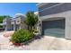 Contemporary townhouse exterior with gray facade, private garages, and colorful, mature landscaping at 295 N Rural Rd # 160, Chandler, AZ 85226