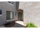 Townhouse entrance with a well-lit doorway, a welcoming mat, and attractive, low-maintenance landscaping at 295 N Rural Rd # 160, Chandler, AZ 85226