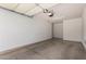 Spacious two-car garage with concrete flooring, providing ample parking and storage space at 295 N Rural Rd # 160, Chandler, AZ 85226