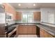 This kitchen offers tile floors, granite countertops, stainless appliances and wood cabinets at 295 N Rural Rd # 160, Chandler, AZ 85226