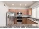 Charming kitchen with wooden cabinets, stainless steel appliances, and a breakfast bar overlooking the dining area at 295 N Rural Rd # 160, Chandler, AZ 85226