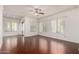 Spacious living room with hardwood floors, ample natural light from multiple windows, and a ceiling fan at 295 N Rural Rd # 160, Chandler, AZ 85226