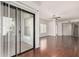 Well-lit living room with hardwood floors, large windows, and a sliding glass door to the outside at 295 N Rural Rd # 160, Chandler, AZ 85226